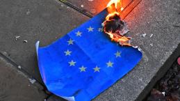 Pro-Brexit supporters burn an EU flag during a UKIP demonstration in central London